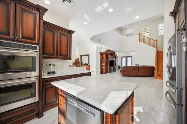 a kitchen with granite countertop a stove and cabinets