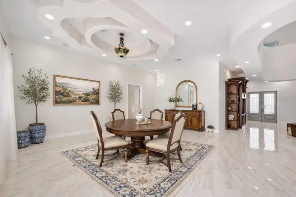 a dining room with furniture and a chandelier