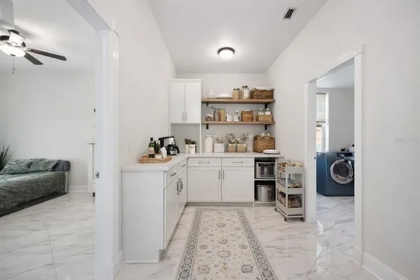 a room with a white cabinets and washer