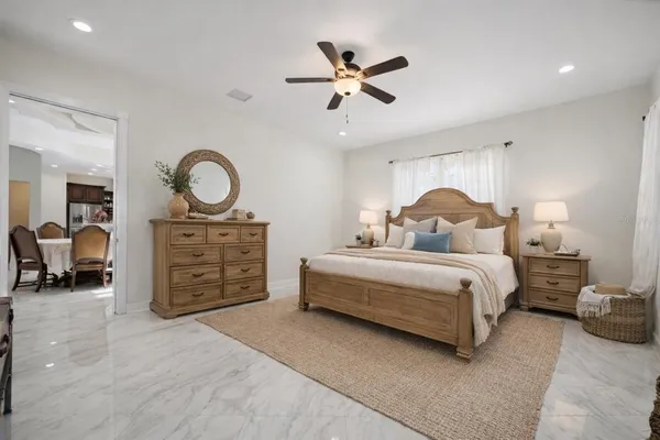a bedroom with a large bed and a chandelier