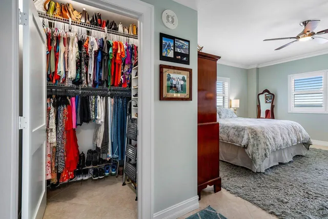 a bed room with a bed a walk in closet and a window