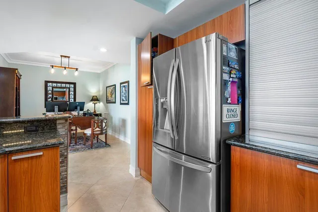 a kitchen with stainless steel appliances granite countertop a refrigerator and a stove