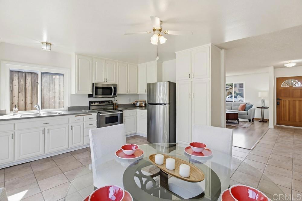 13001 Standish Drive Poway, CA 92064 - Photo 11 of 36 a kitchen with stainless steel appliances kitchen island granite countertop a refrigerator and microwave