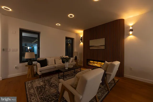 a patio with table and chairs and potted plants