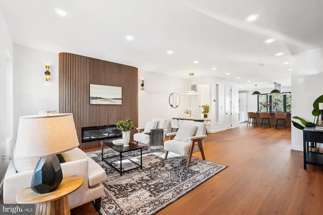a view of a hallway with wooden floor and windows