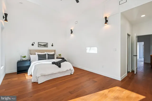 a living room with furniture a rug and white walls