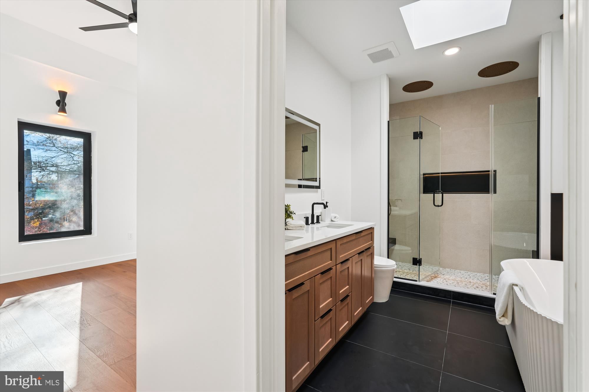 951 Shepherd Street Northwest Washington, DC 20011 - Photo 38 of 74 a bathroom with a double vanity sink a mirror and a bathtub
