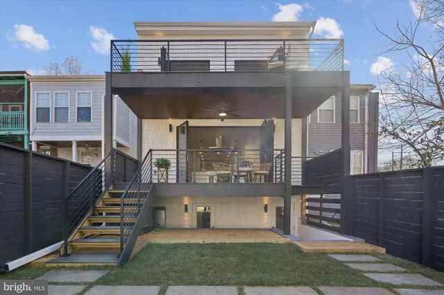 a kitchen with stainless steel appliances a stove a sink cabinets and a window