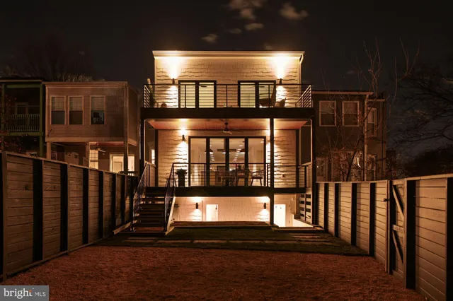a kitchen with white cabinets and a window