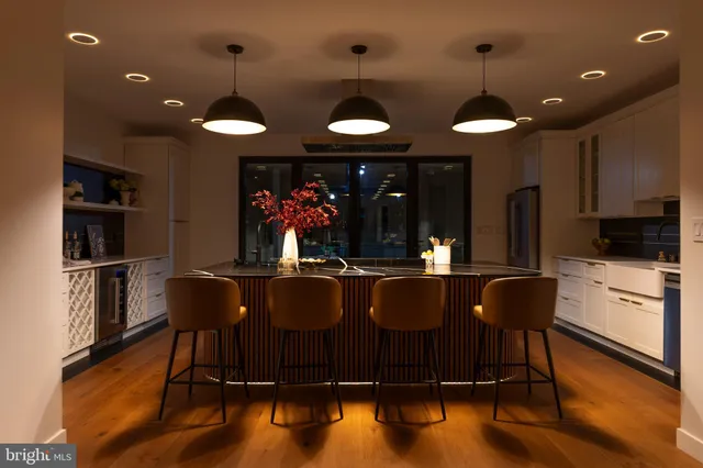 a kitchen with stainless steel appliances granite countertop a stove and white cabinets