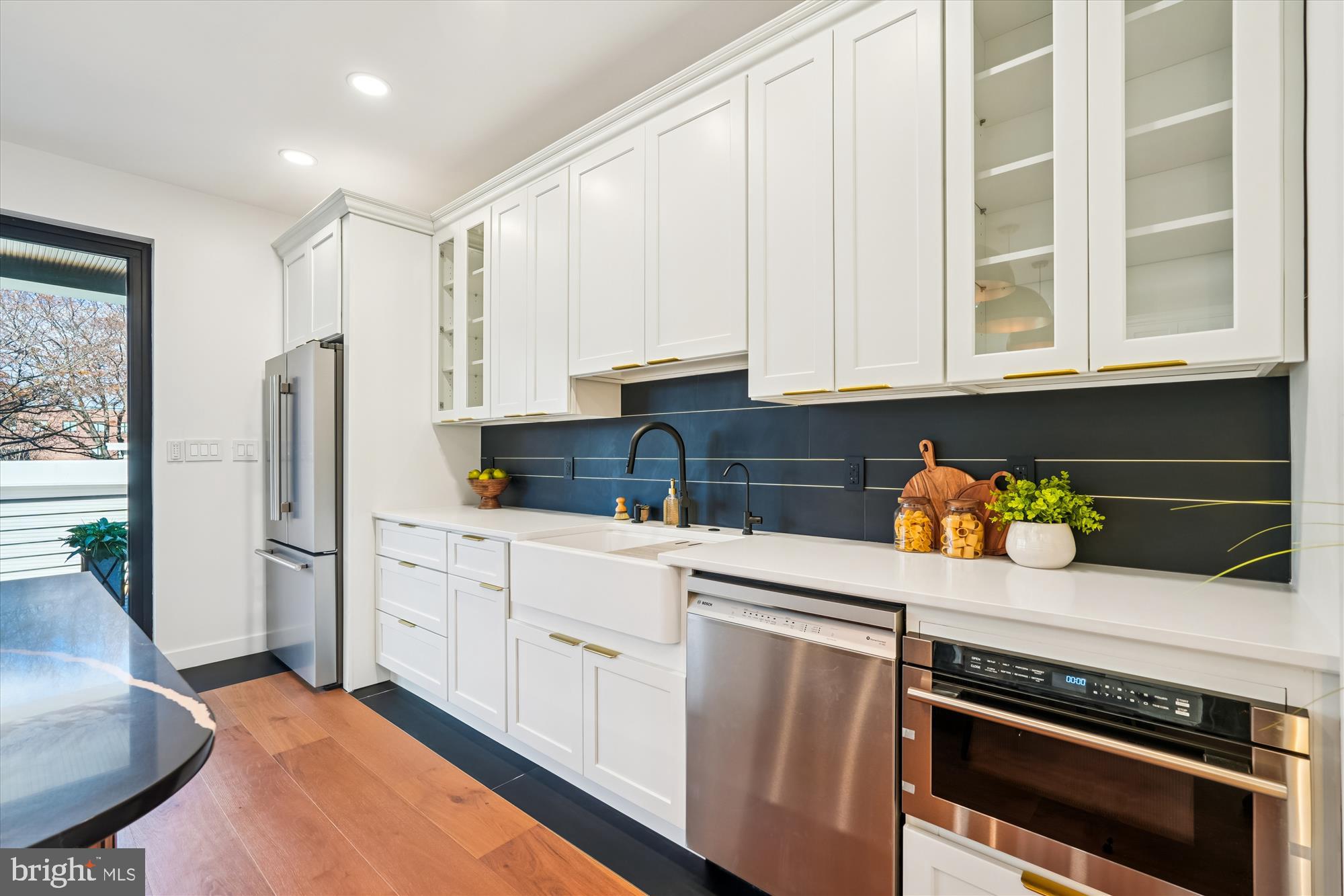 951 Shepherd Street Northwest Washington, DC 20011 - Photo 8 of 74 a kitchen with stainless steel appliances a stove a sink cabinets and a window