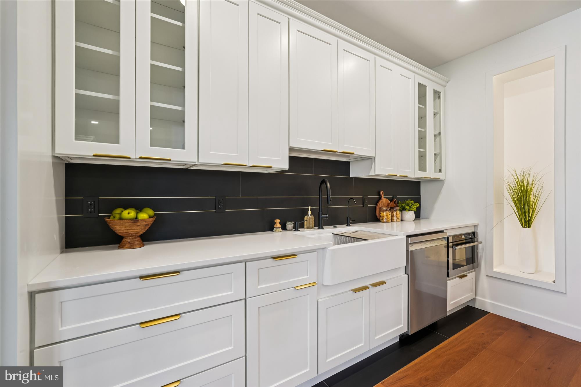 951 Shepherd Street Northwest Washington, DC 20011 - Photo 9 of 74 a kitchen with white cabinets and a window