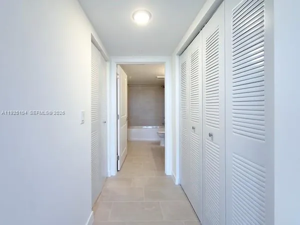 a view of a hallway with a wooden floor