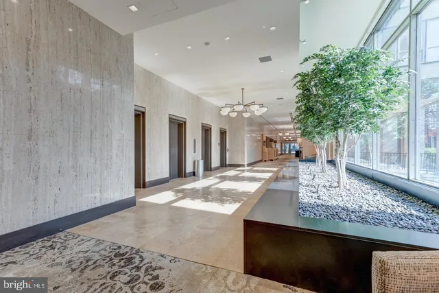 a living room with kitchen island granite countertop furniture and a rug