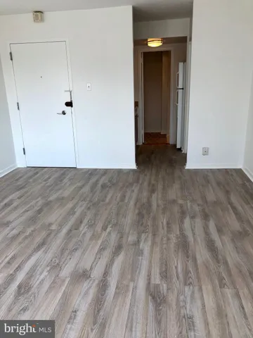a view of a room with wooden floor