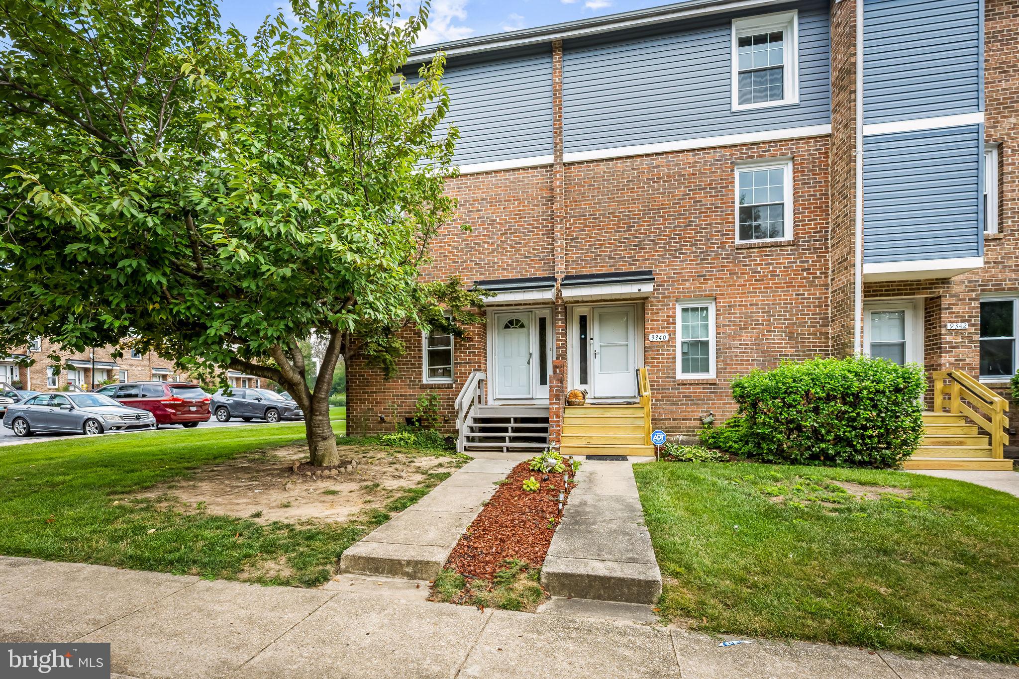 9338 Canterbury Riding Laurel, MD 20723 - Photo 2 of 34 Charming brick facade with lush greenery.