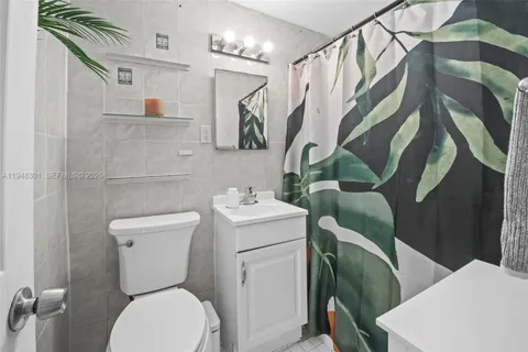 a white toilet sitting next to a bathroom sink