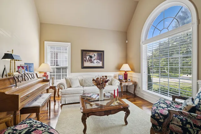 a living room with furniture and a floor to ceiling window