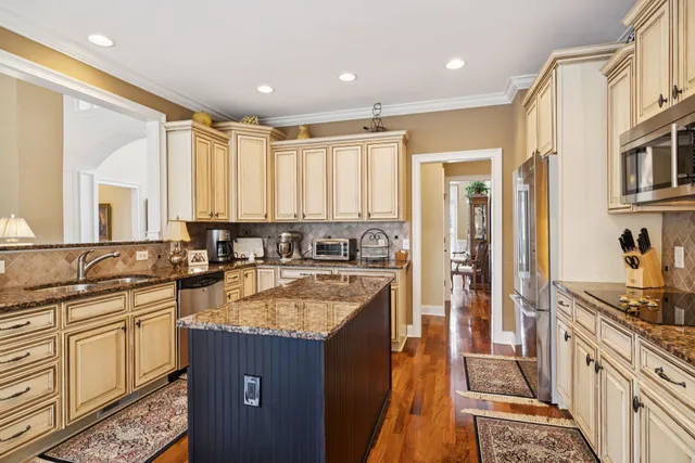 a kitchen with granite countertop a sink and a stove top oven