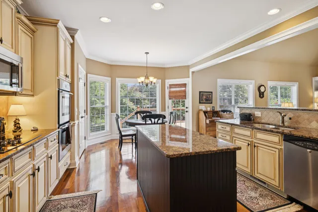 a kitchen with stainless steel appliances granite countertop a refrigerator sink and cabinets