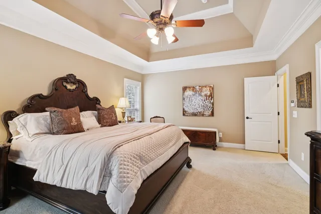 a spacious bedroom with a bed and a chandelier