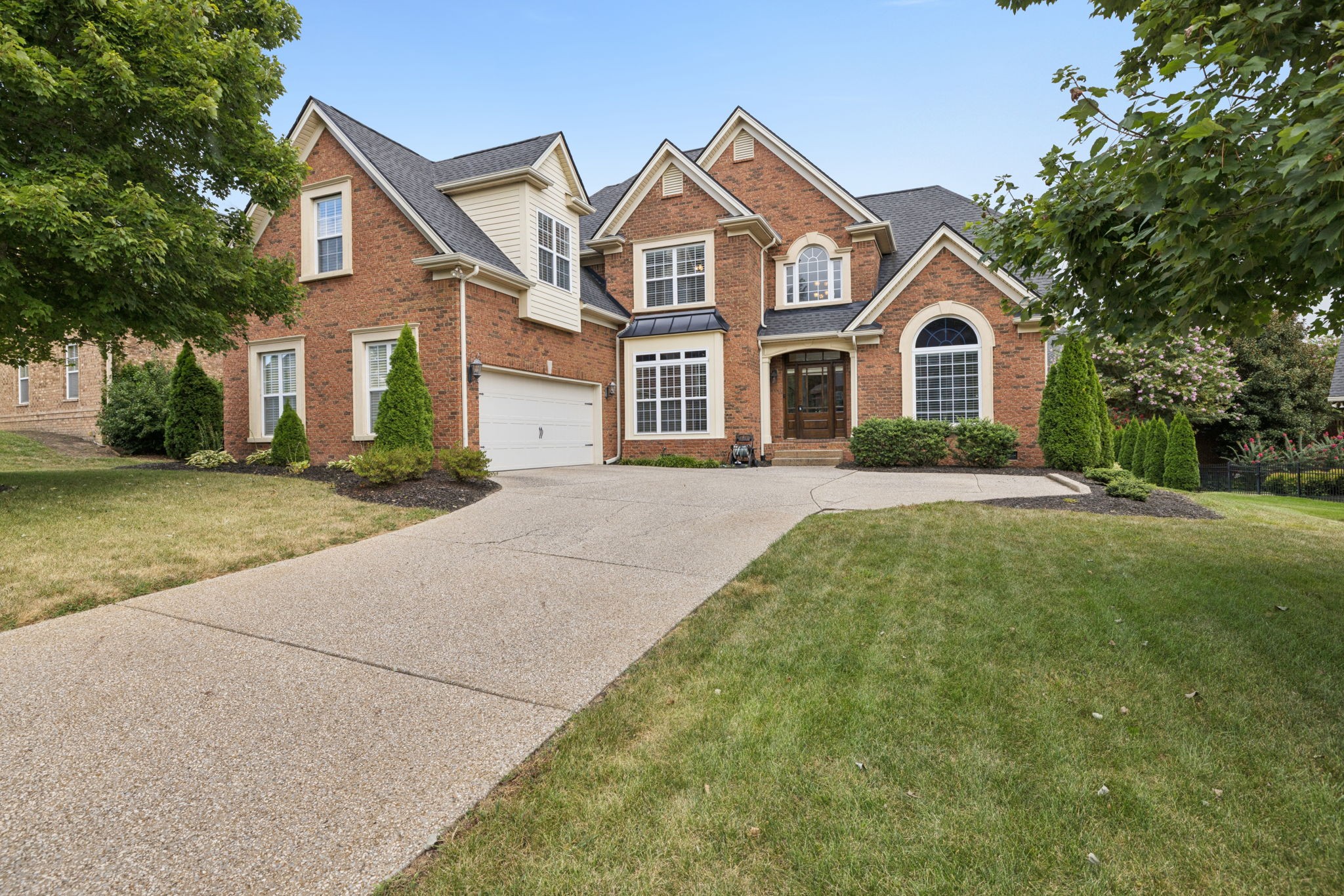 2999 Stewart Campbell Pointe Spring Hill, TN 37174 - Photo 3 of 50 a front view of a house with a garden and trees