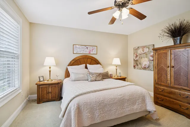 a bed room with a bed and a chair