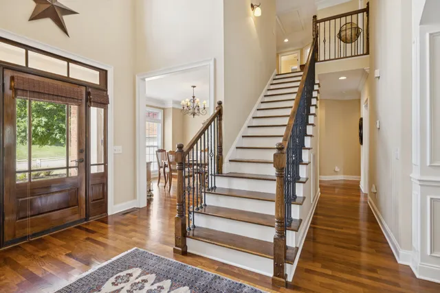 a view of entryway and hall with wooden floor