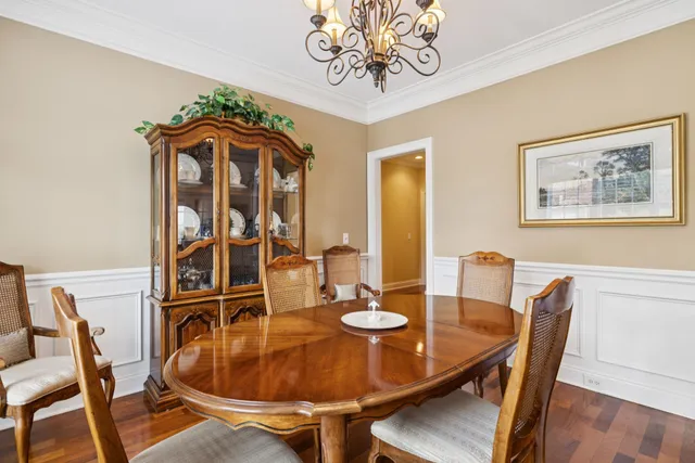 a dining room with furniture and wooden floor