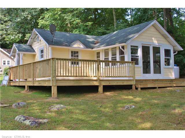 a view of a house with pool and deck