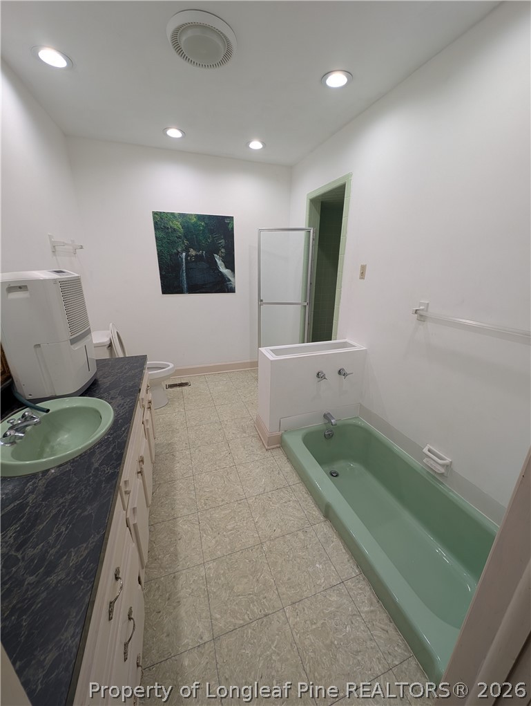 1503 Lakeview Road Fairmont, NC 28340 - Photo 15 of 30 a bathroom with a sink a toilet and mirror