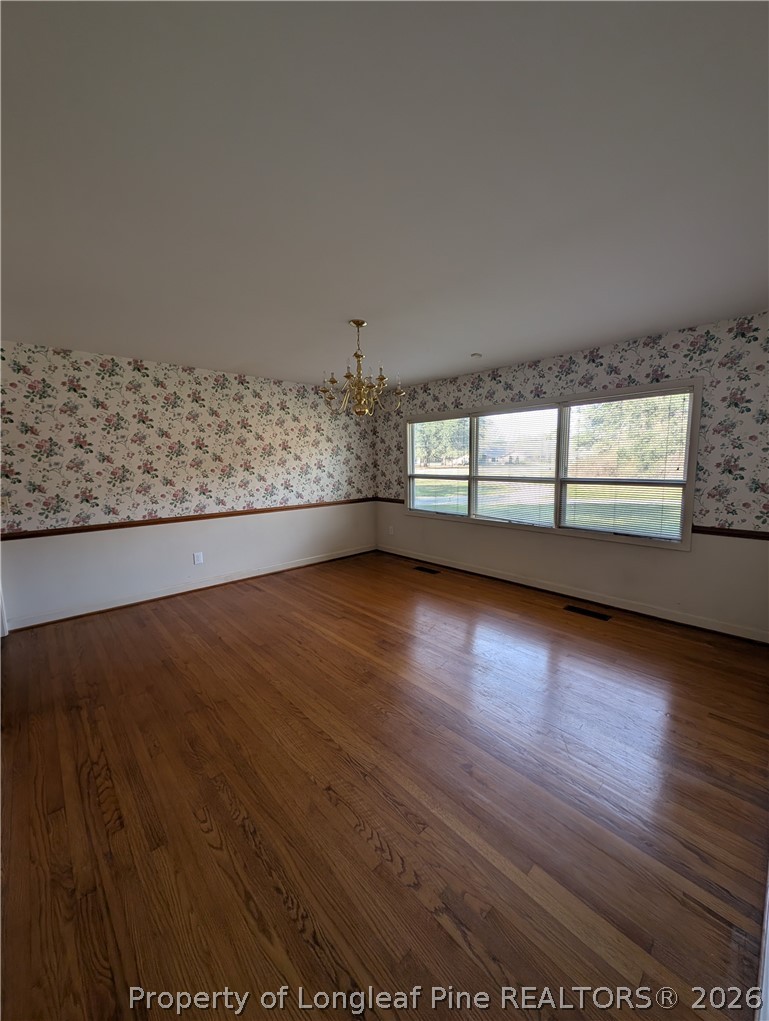 1503 Lakeview Road Fairmont, NC 28340 - Photo 19 of 30 an empty room with wooden floor and windows