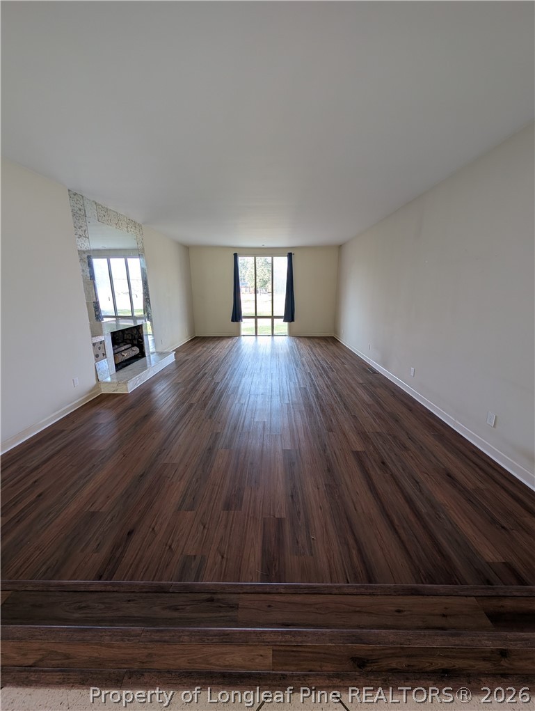 1503 Lakeview Road Fairmont, NC 28340 - Photo 7 of 30 a view of empty room with wooden floor and fan