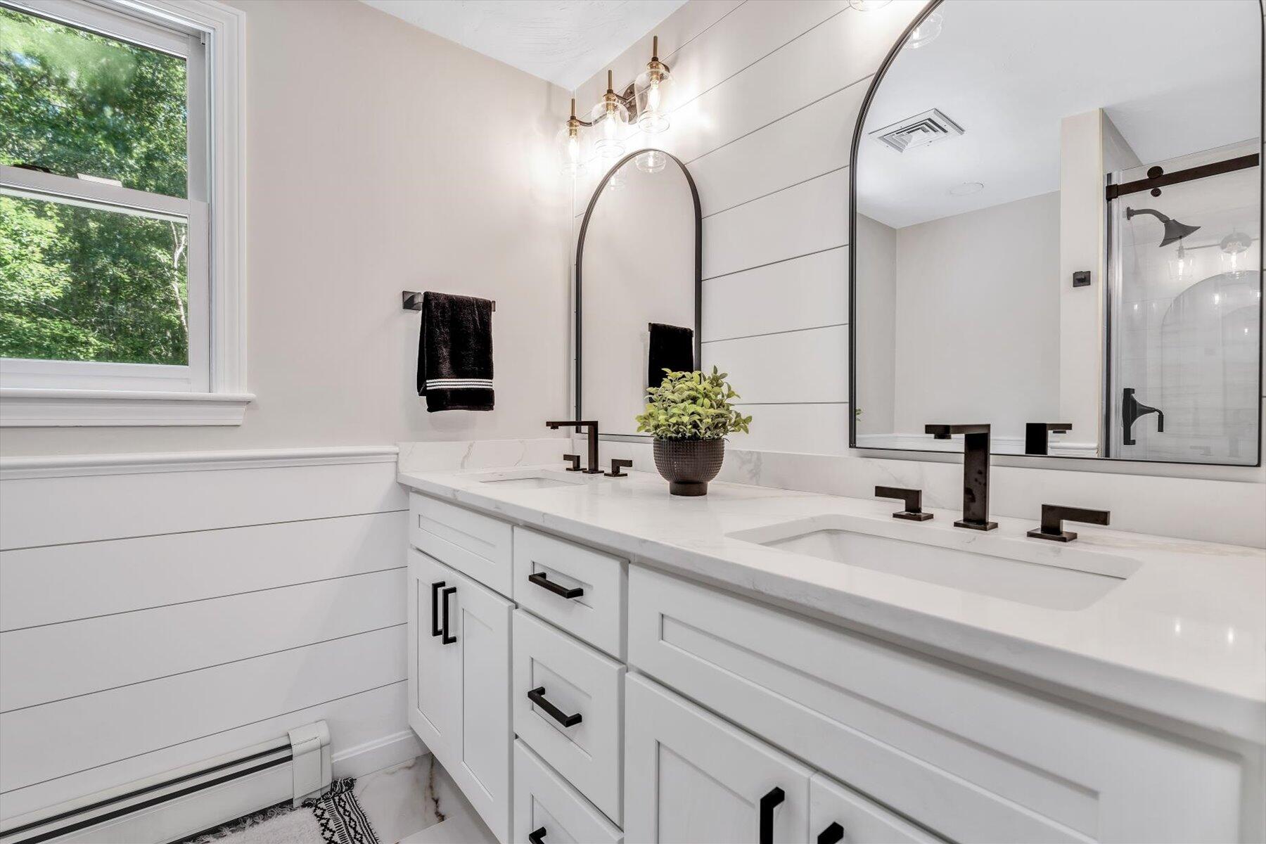 29 Fish House Road East Sandwich, MA 02537 - Photo 33 of 50 a bathroom with a double vanity sink and mirror