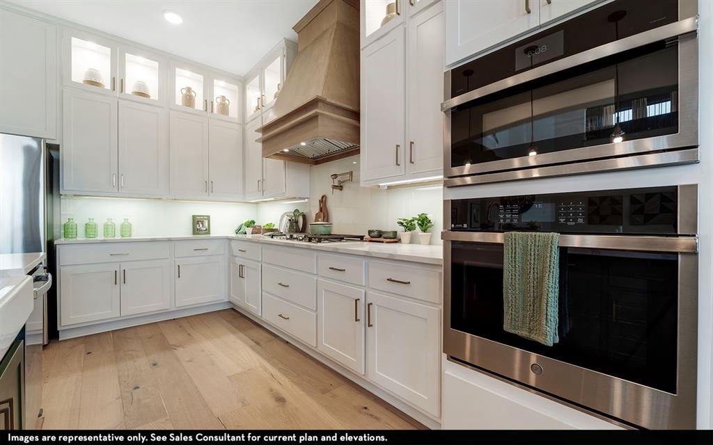16301 Flatlands Way Celina, TX 75009 - Photo 20 of 39 a kitchen with stainless steel appliances granite countertop a stove microwave and cabinets