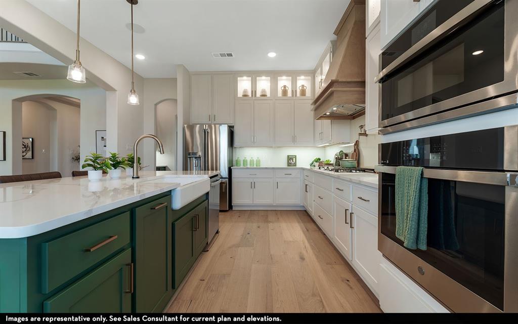 16301 Flatlands Way Celina, TX 75009 - Photo 21 of 39 a large kitchen with stainless steel appliances kitchen island granite countertop a sink a counter space and cabinets