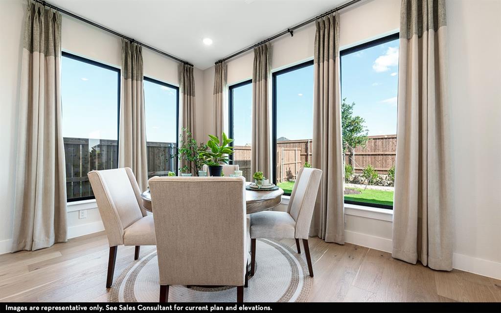 16301 Flatlands Way Celina, TX 75009 - Photo 23 of 39 a view of a dining room with furniture window and wooden floor