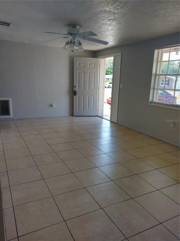 5112 Janice Lane Holiday, FL 34690 - Photo 2 of 10 an empty room with a empty space and windows
