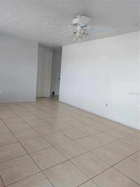 5112 Janice Lane Holiday, FL 34690 - Photo 3 of 10 an empty room with a chandelier fan
