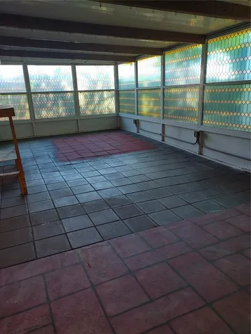 a view of empty room with floor to ceiling window