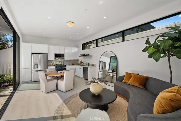 a dining room with furniture and a floor to ceiling window