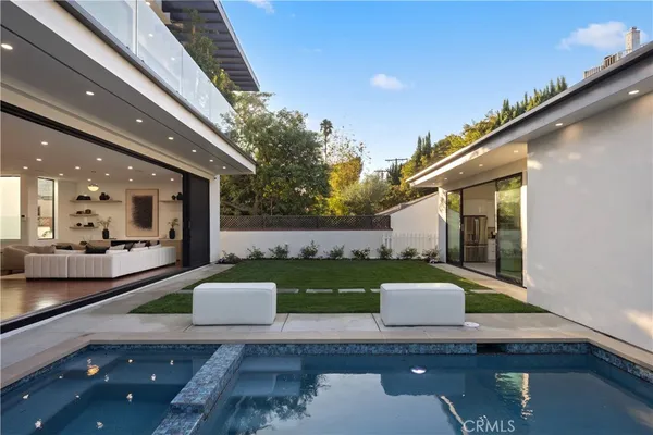 a view of a house with a porch and a yard