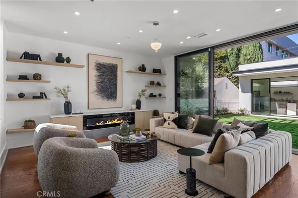 a living room with furniture and kitchen view