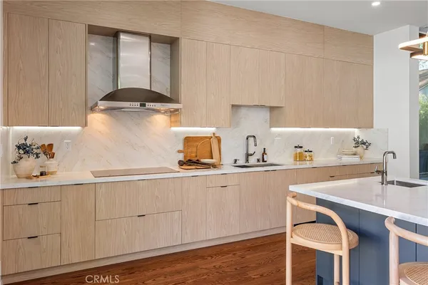 a kitchen with counter top space a sink appliances and cabinets