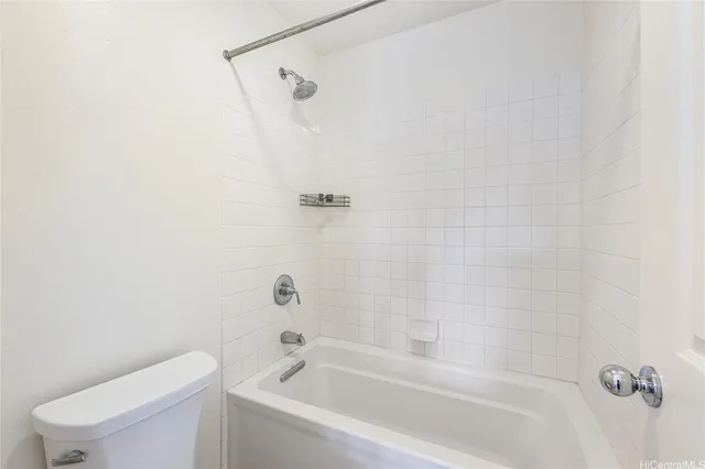 a bathroom with a bathtub and a toilet