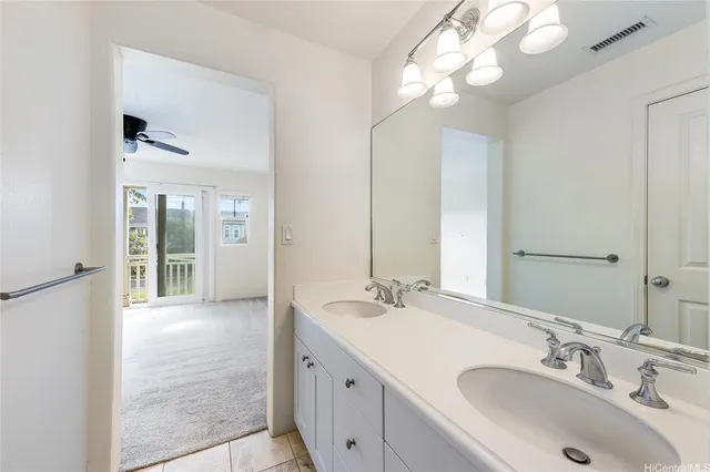 a bathroom with a sink vanity and a mirror