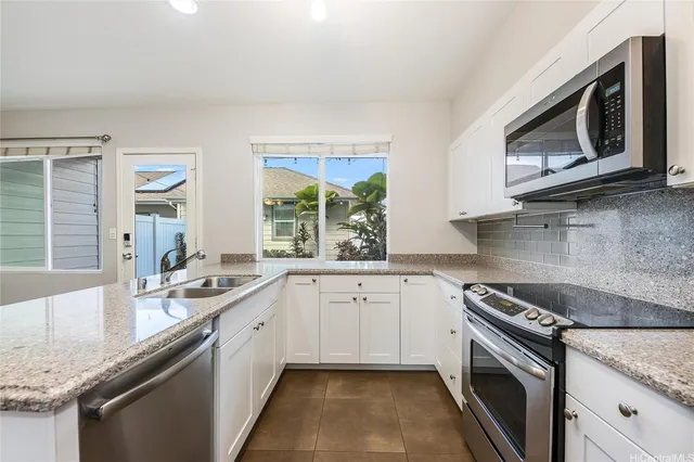 a kitchen with a sink stove and microwave