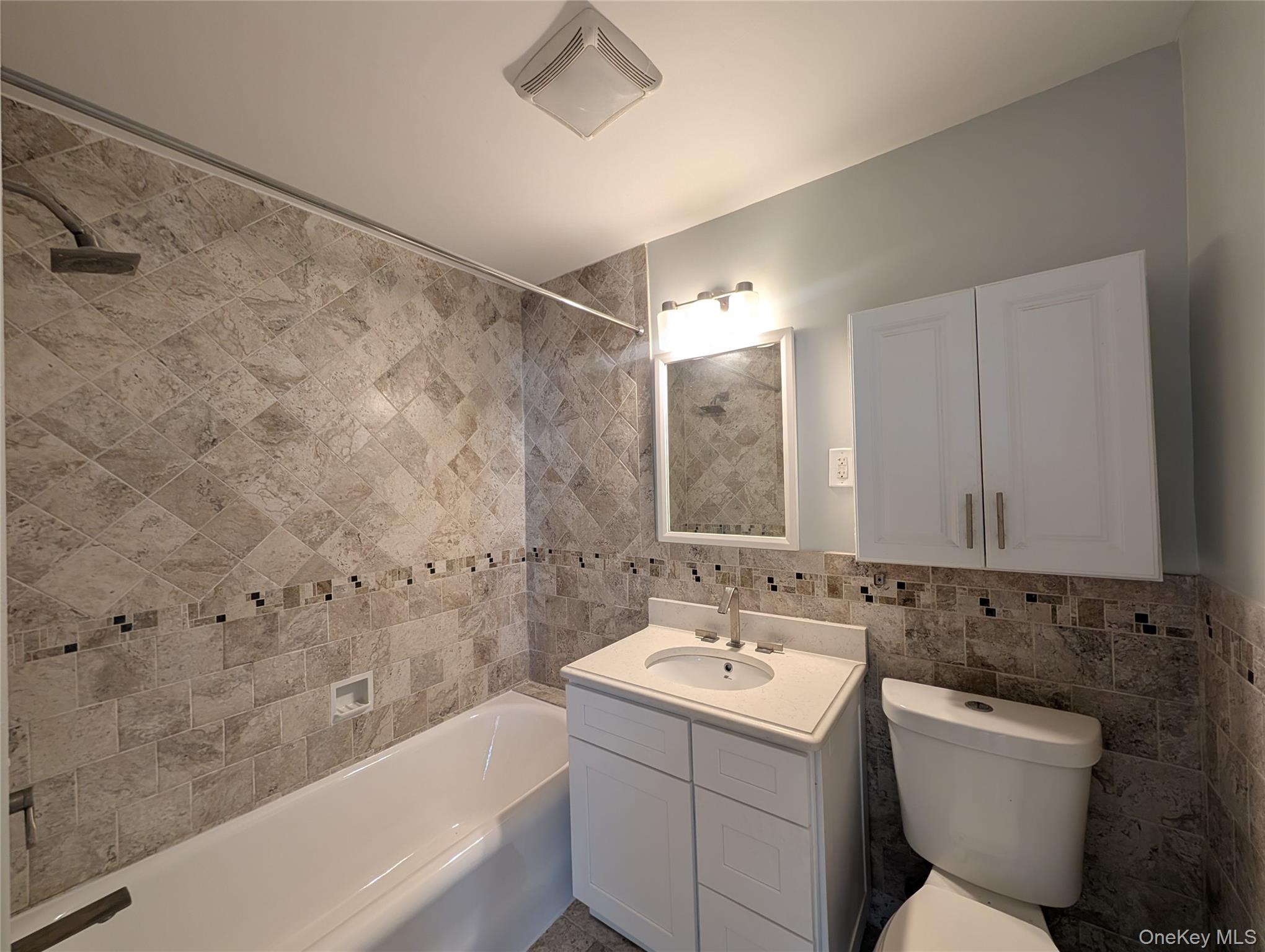 26 Coligni Avenue, Unit 12 New Rochelle, NY 10801 - Photo 13 of 18 a bathroom with a sink mirror toilet and bathtub