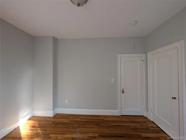 a view of room with wooden floor