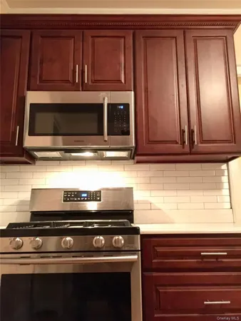 a kitchen with stove and microwave